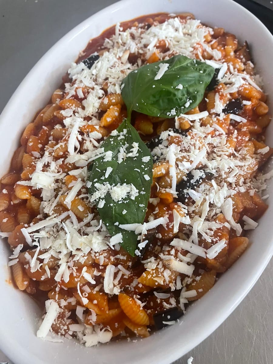 Gnocchetti al pomodoro con melanzane, ricotta salata grattugiata e foglie di basilico fresco